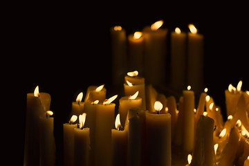 Image showing Light many candles burning in the black background