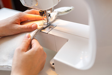 Image showing Girl working on sewing machine