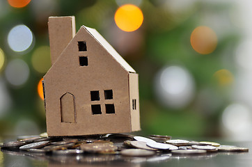 Image showing Model of house with coins on wooden table