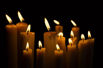 Image showing Light many candles burning in the black background