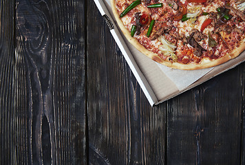 Image showing Pizza on a wooden table