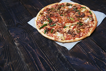 Image showing Homemade pizza on a wooden table