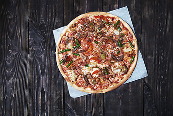 Image showing Homemade pizza on a wooden table