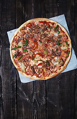 Image showing Homemade pizza on a wooden table