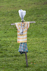 Image showing Scarecrow made of old clothes in a field