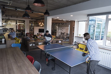 Image showing playing ping pong tennis at creative office space