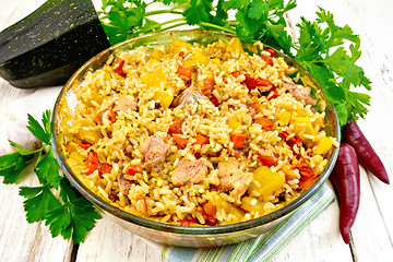 Image showing Rice with chicken and zucchini in glass pan on light board