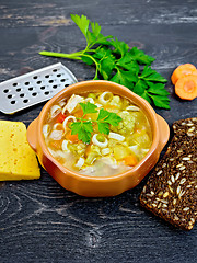 Image showing Soup Minestrone in clay bowl on black board