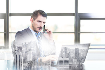 Image showing Businessman in office working on laptop computer.