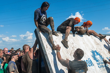 Image showing Athletes storm wall in extrim race. Tyumen.Russia