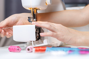 Image showing Girl starts tailoring on sewing-machine