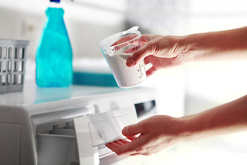 Image showing hands of woman that fills detergent