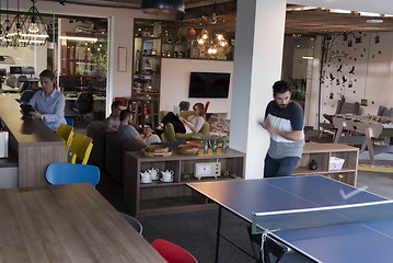 Image showing playing ping pong tennis at creative office space