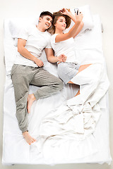 Image showing The young lovely couple lying in a bed