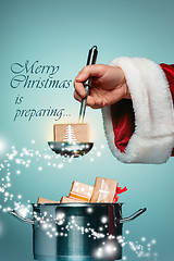 Image showing The Santa hand holding a ladle or kitchen spoon