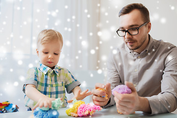 Image showing father and son playing with ball clay at home