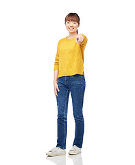 Image showing happy asian young woman pointing finger on you