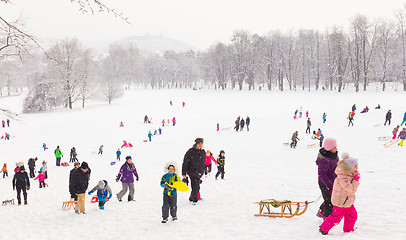 Image showing Winter fun, snow, family sledding at winter time.