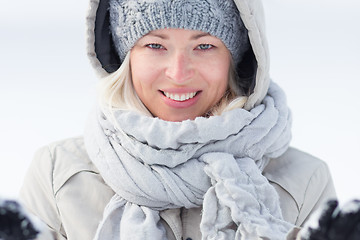 Image showing Girl  playing with snow in winter.