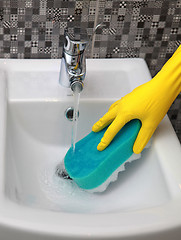 Image showing Hand in yelow glove with sponge