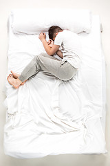 Image showing The young man lying in a bed