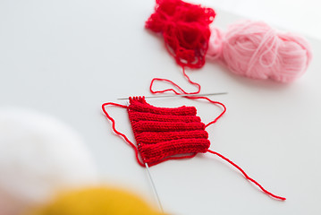 Image showing hand-knitted item with knitting needles