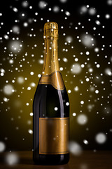 Image showing bottle of champagne with golden label over snow