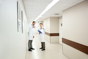 Image showing male doctors with clipboard at hospital