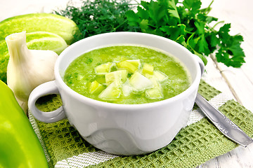 Image showing Soup cucumber with peppers in white bowl on board