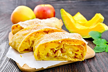 Image showing Strudel pumpkin and apple on wooden board