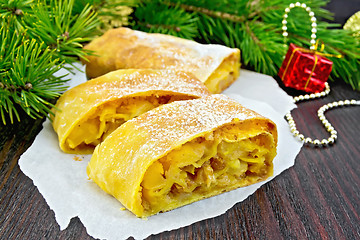 Image showing Strudel pumpkin and apple with Christmas toys on board