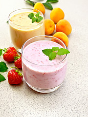 Image showing Milkshake strawberry and apricot on granite table