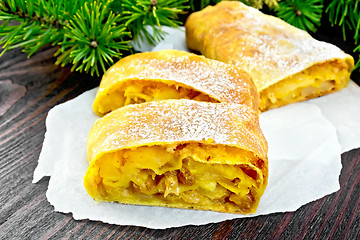 Image showing Strudel pumpkin and apple with pine branches on dark board