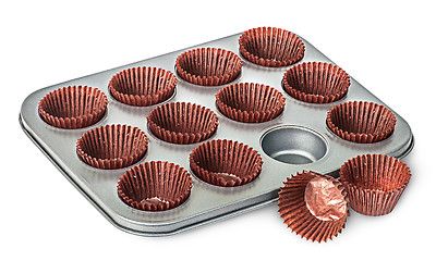 Image showing Cupcake and muffin pan with paper cups some beside