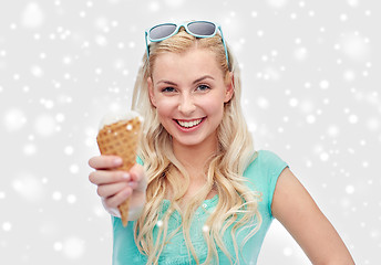 Image showing happy young woman in sunglasses eating ice cream