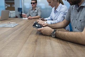 Image showing close up of  businessman hands  using tablet on meeting