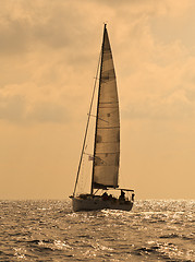 Image showing Yacht sailing against sunset