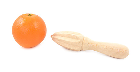 Image showing Whole orange and wooden citrus reamer