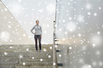 Image showing sporty woman standing on in city stairs