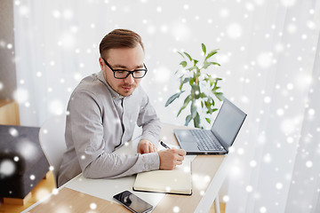 Image showing creative man or businessman writing to notebook