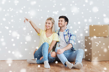 Image showing couple with boxes moving to new home and dreaming