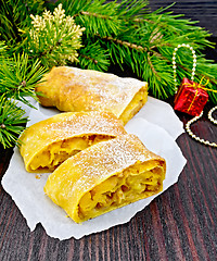 Image showing Strudel pumpkin and apple with pine branches on board