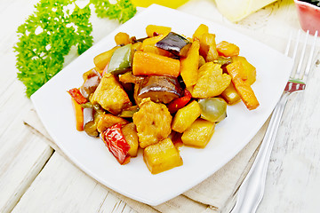 Image showing Roast with vegetables and honey in plate on light board