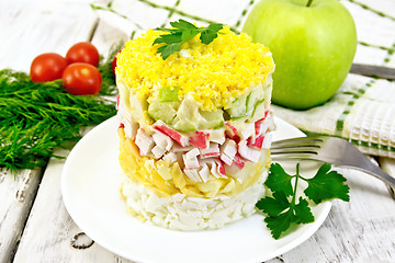 Image showing Salad of crab sticks and apple on light board