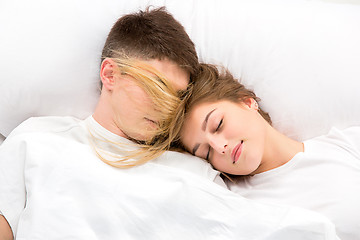 Image showing The young lovely couple lying in a bed