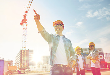 Image showing builders pointing finger aside on construction