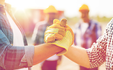 Image showing close up of builders hands making handshake