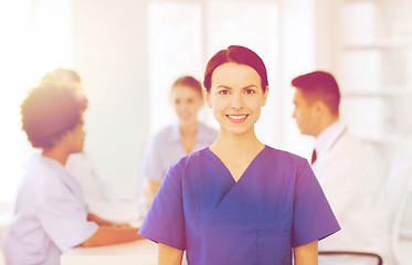 Image showing happy doctor over group of medics at hospital