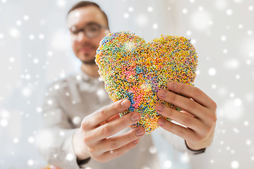 Image showing happy man with heart made of ball clay