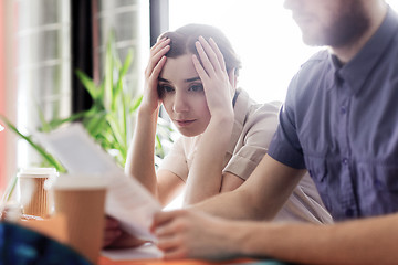 Image showing creative team with reading paper in office